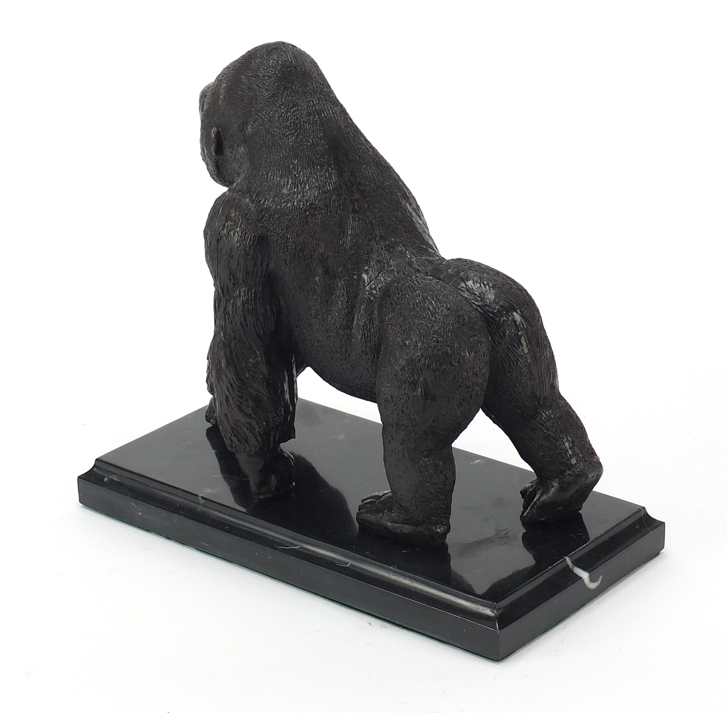 Patinated bronze gorilla raised on a black marble base, 20cm wide - Image 2 of 3
