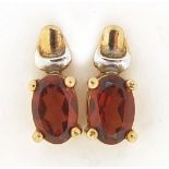 Pair of 9ct gold garnet stud earrings, 9mm high, 1.3g