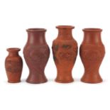 Four Japanese Tokoname terracotta dragon vases, two with seal marks to the bases, the largest 25cm