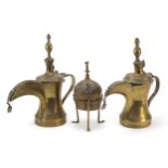 Middle Eastern metalware comprising two Omani Dallah coffee pots and a Cairoware incense burner with