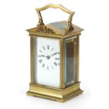 French brass cased carriage clock with enamelled dial having Roman numerals, 13cm high excluding the