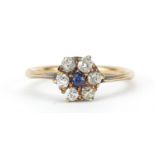 Unmarked gold diamond and sapphire flower head ring, the diamonds approximately 2.2mm in diameter,