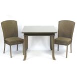 Square Lloyd loom table with glass top and two chairs, the table 75cm high x 90cm square