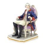 19th century porcelain Naples figurine depicting a man seated with a walking stick, 17.5cm high