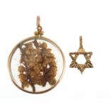 9ct gold open locket with dried flower and a 9ct gold star of David pendant, the largest 3cm high,