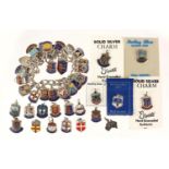 Silver charm bracelet with a large selection of enamelled silver souvenir shield charms, 67.0g