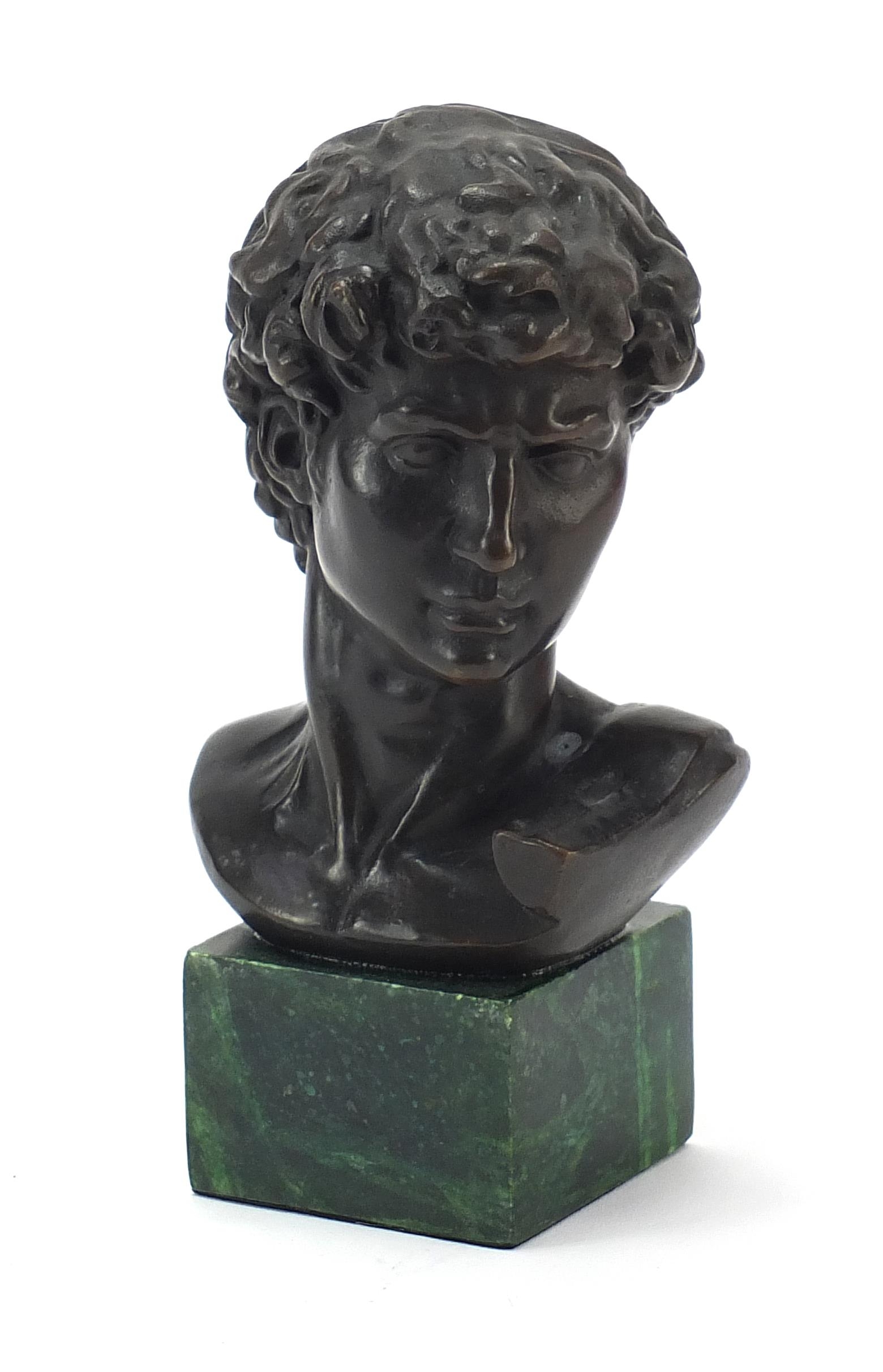 Patinated bronze bust of David raised on a green marbleised base, 17cm high