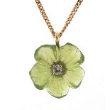 9ct gold carved peridot and diamond flower head pendant on a 9ct gold necklace, 1.5cm high and