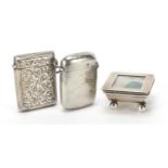Two rectangular silver vestas and a silver stamp box with hinged lid, various hallmarks, the largest