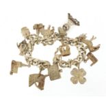 Silver charm bracelet with a selection of mostly silver charms including opening church, opening