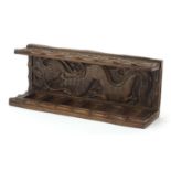 Chinese hardwood six section pipe rack carved with a dragon, 10cm H x 27.5cm W x 7.5cm D