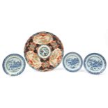 Three Chinese blue and white plates depicting fishermen and a village and a large Imari dish, the
