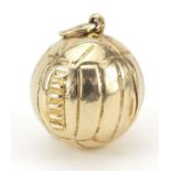 9ct gold football charm opening to reveal a goalkeeper, 1.7cm in diameter, 6.7g