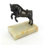 Patinated bronze study of a rearing bull raised on rectangular onyx base, 19cm high