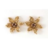 Pair of 9ct gold garnet flower head stud earrings, 1.1cm in diameter, 1.7g