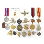 British militaria including cap badges and four World War II medals