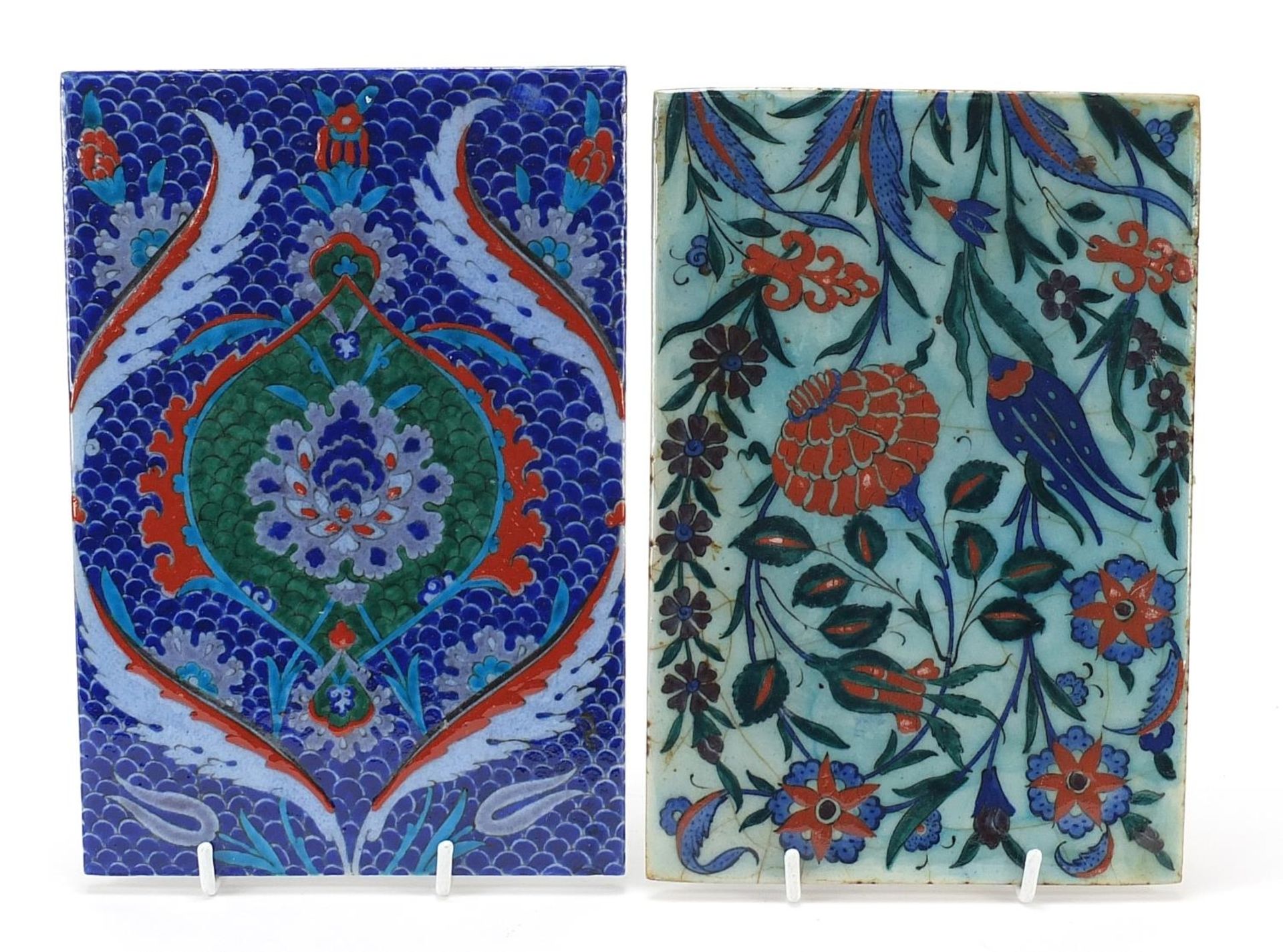 Two Turkish Iznik pottery tiles hand painted with flowers, the largest 24.5cm x 16.5cm