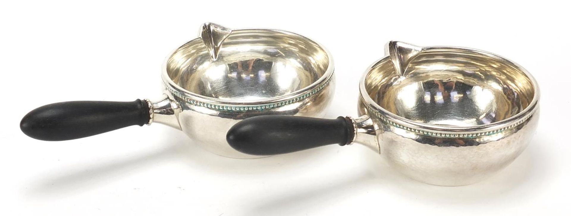 Georg Jensen, pair of Danish 925S silver porringers with ebony handles, 16.5cm in length, 304.0g - Image 2 of 3