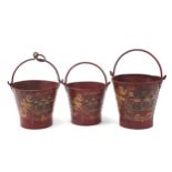 Graduated set of three Coca Cola design painted metal buckets with swing handles, the largest 30cm
