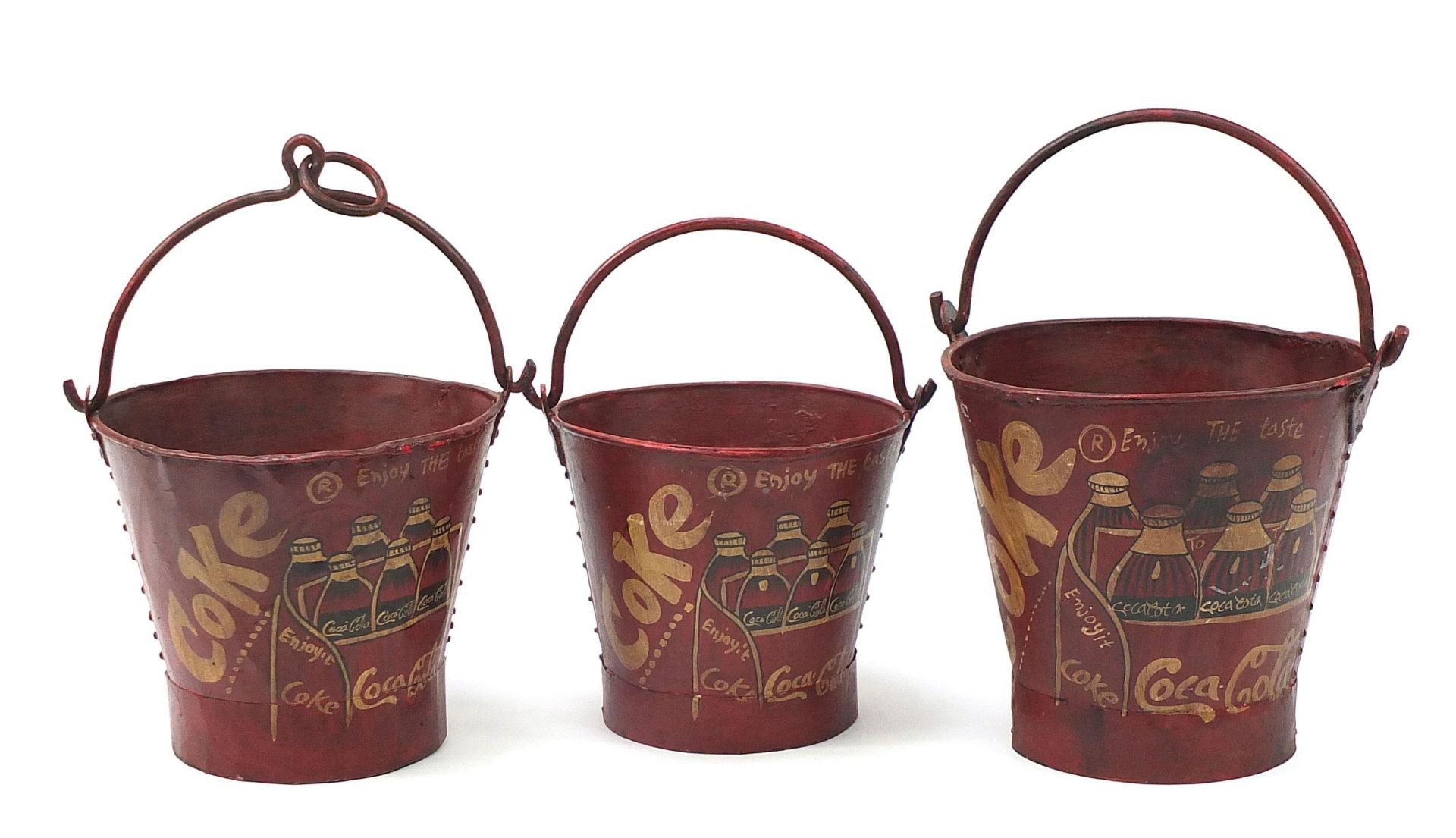 Graduated set of three Coca Cola design painted metal buckets with swing handles, the largest 30cm