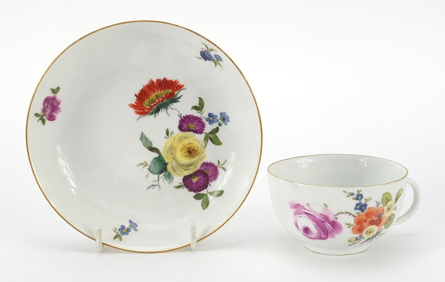 Meissen, 19th century porcelain cup and saucer hand painted with flowers, the saucer 13.5cm in