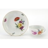 Meissen, 19th century porcelain cup and saucer hand painted with flowers, the saucer 13.5cm in