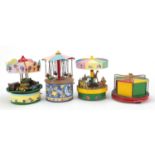 Four scratch wooden motorised models comprising three fairground merry-go-rounds and a roundabout,