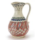 Turkish Kutahya pottery jug hand painted with flowers, 25cm high