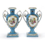 Pair of French blue porcelain vases with twin handles decorated with flowers, each 33cm high