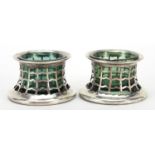 Pair of Edwardian pierced silver open salts with green glass liners, indistinct maker's mark