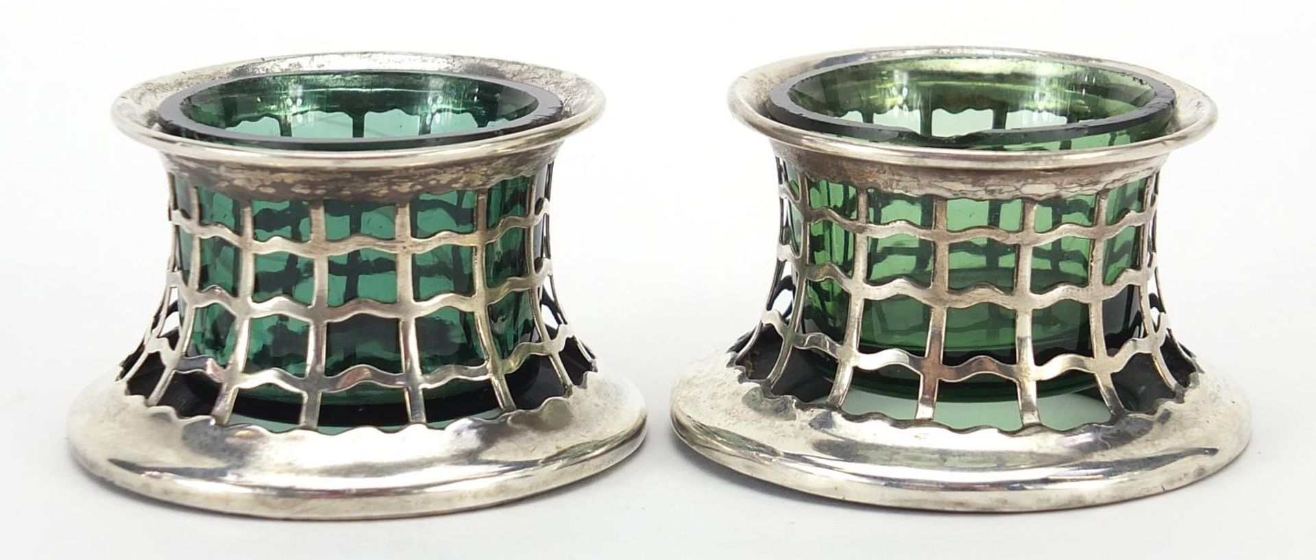 Pair of Edwardian pierced silver open salts with green glass liners, indistinct maker's mark