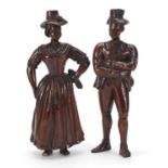 Pair of antique continental wood carvings of peasants in 18th century dress, the largest 22cm high