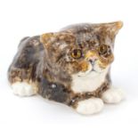 Winstanley pottery recumbent cat with glass eyes, 25cm in length