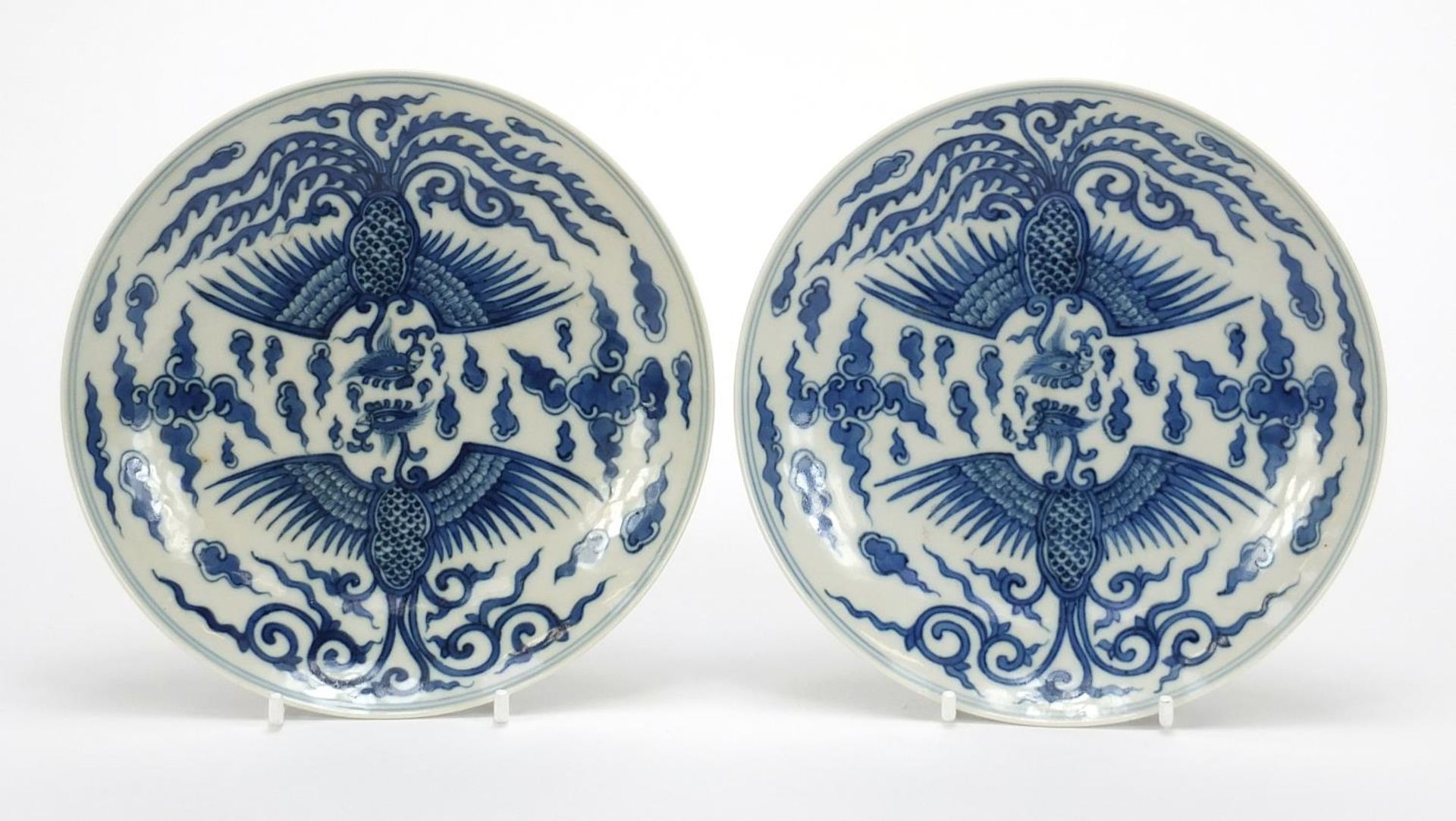 Pair of Chinese blue and white porcelain dishes hand painted with phoenixes amongst clouds, each