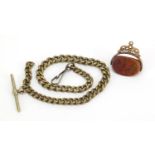 Unmarked gold hardstone spinner fob and a gilt metal watch chain with T-bar, the fob 3cm high