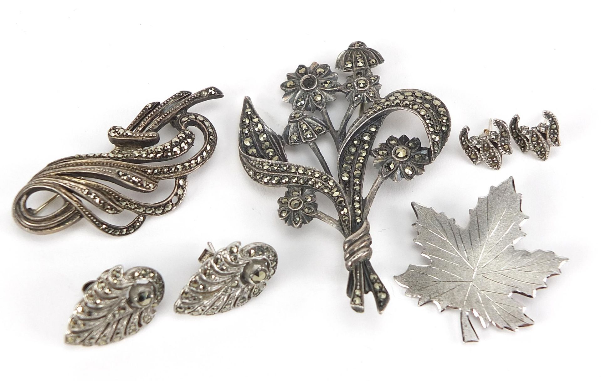 Silver jewellery comprising two marcasite brooches, two pairs of marcasite earrings and a maple leaf