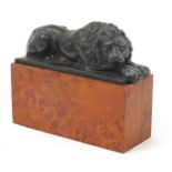 Lion of Lucerne patinated spelter lion, raised on a wooden base, 19cm wide