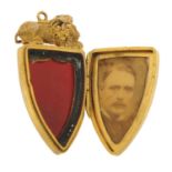 Antique gilt metal and carnelian locket in the form of a sleeping lion on a shield, 4cm high, 10.0g