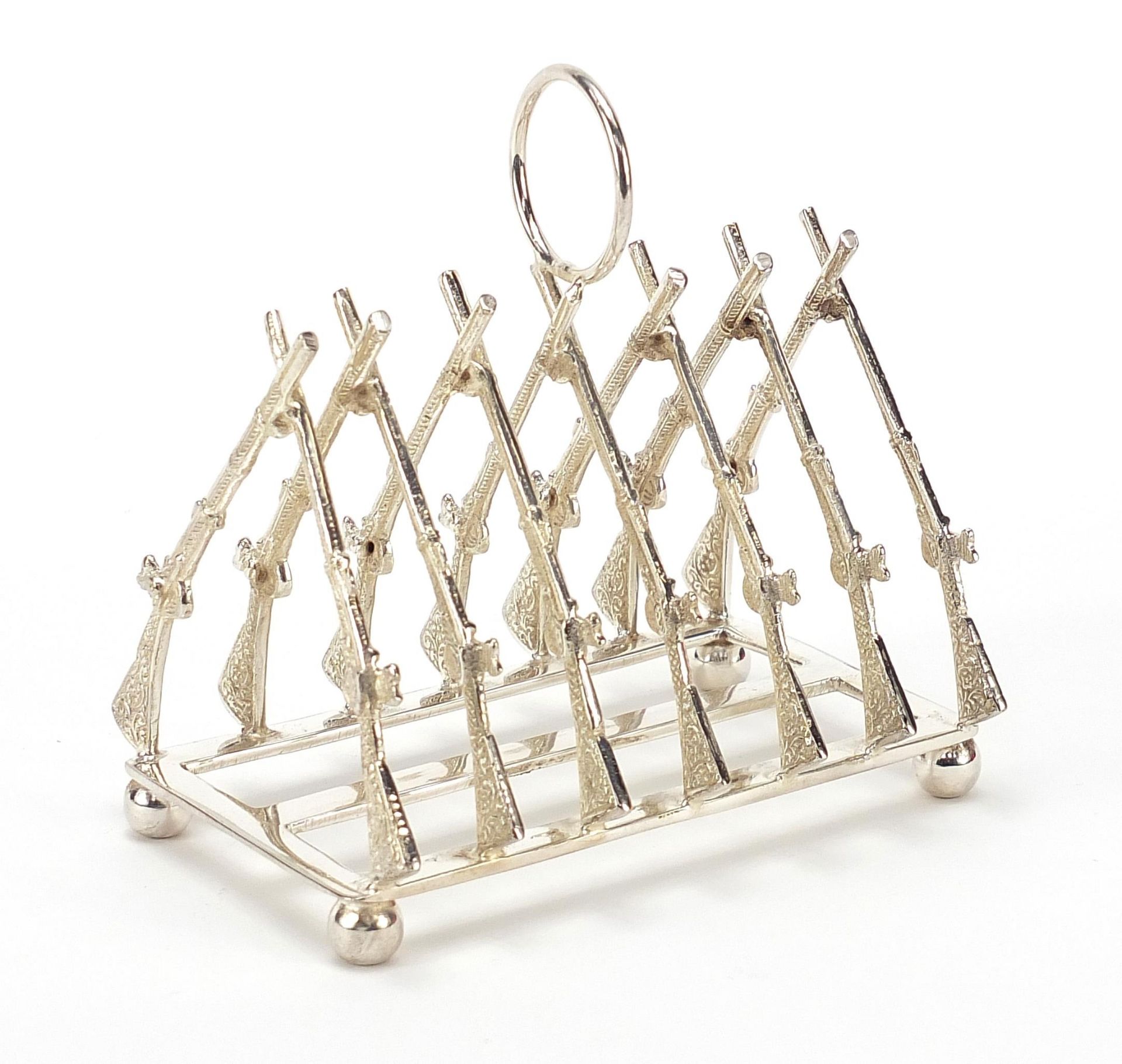 Military interest silver plated six slice toast rack in the form of rifles, 11cm in length