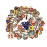 Silver charm bracelet with a large selection of silver and enamel souvenir shield charms, 18cm in