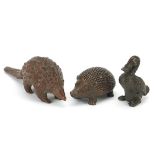 Three Japanese patinated bronze animals comprising armadillo, hedgehog and duck, each with impressed