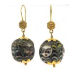 Pair of Islamic unmarked gold mounted glass earrings, hand painted with face masks, 4cm high, 13.0g