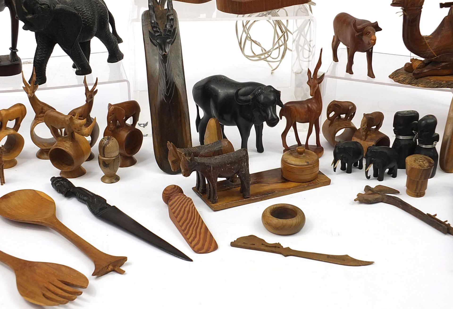 African woodenware to include carved elephants, table lamp, wall plaque, figures and a carving - Image 6 of 7