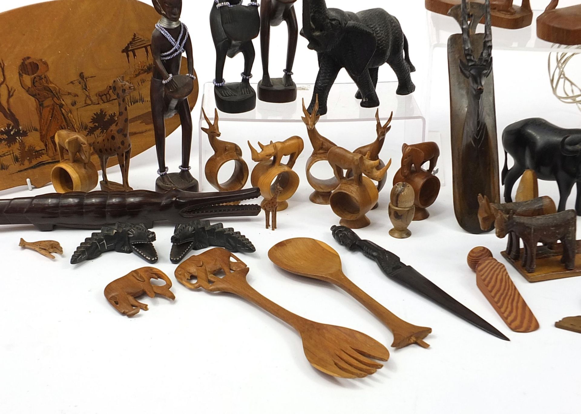 African woodenware to include carved elephants, table lamp, wall plaque, figures and a carving - Image 7 of 7