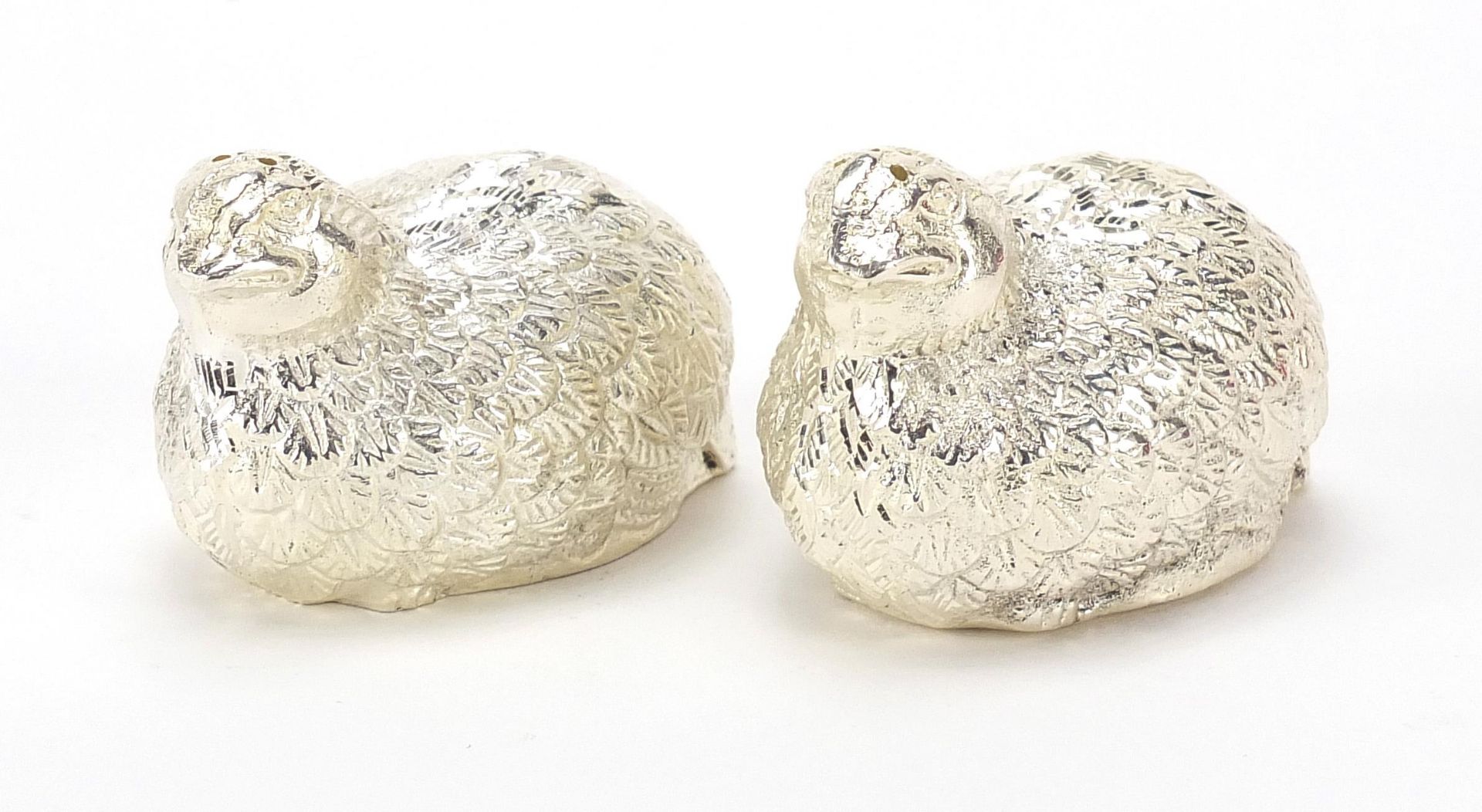 Pair of silvered quail casters, 6cm in length