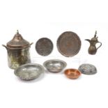 Middle Eastern metalware including an Omani coffee pot and dish engraved with script, the largest