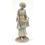 Garden ornament of a young girl holding her dress, 57cm high