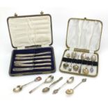 Nine silver souvenir teaspoons, two white metal souvenir teaspoons and five silver handled butter