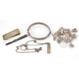 Silver jewellery including charm bracelet, hinged bangle and money clip, 81.2g