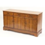 Crossbanded yew side cabinet with three drawers above three cupboard doors, 76cm H x 140cm W x